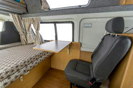 Comfy seat with desk inside Endeavour Campervan from Hippie Campers
